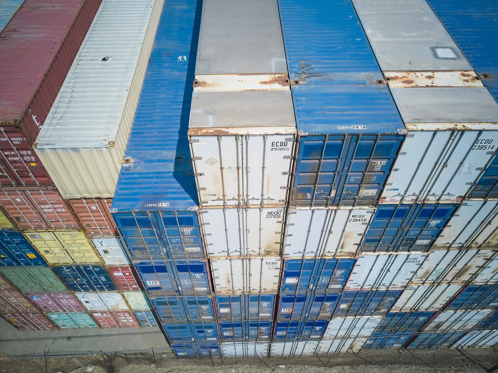 Aerial view of shipping containers arranged in an export logistics yard.