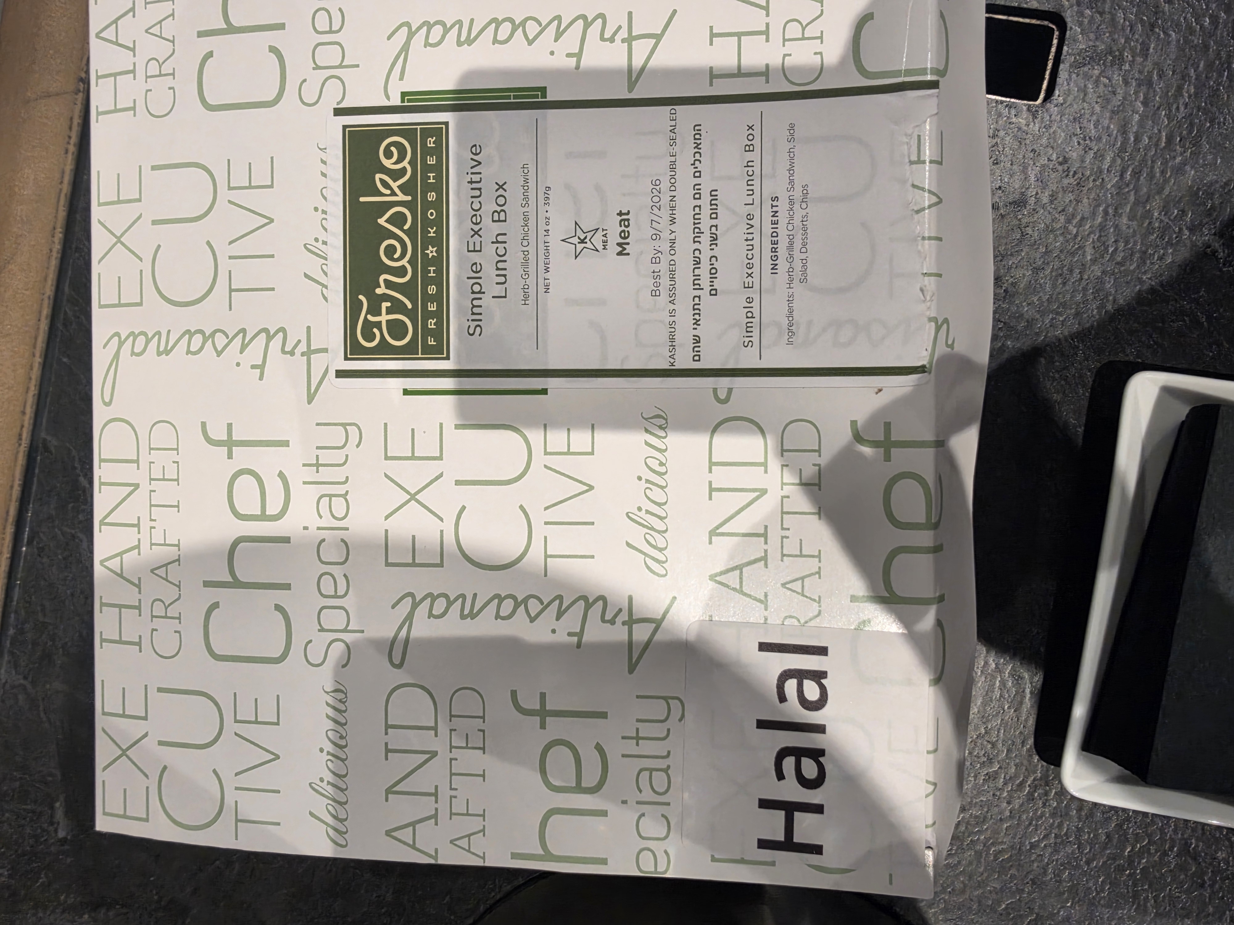 Original photograph of a Fresko executive lunch box showing the word Halal on the outer package and kosher marks on the meat-product label.