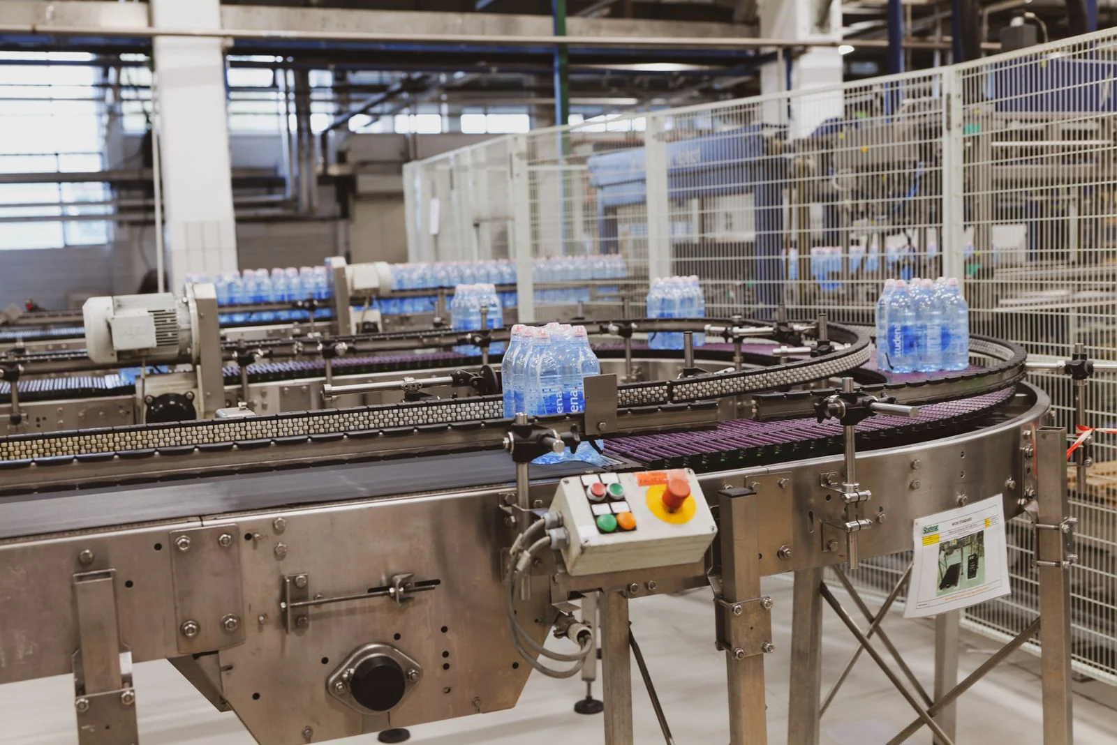 Water bottles on an automated conveyor in a modern beverage production facility